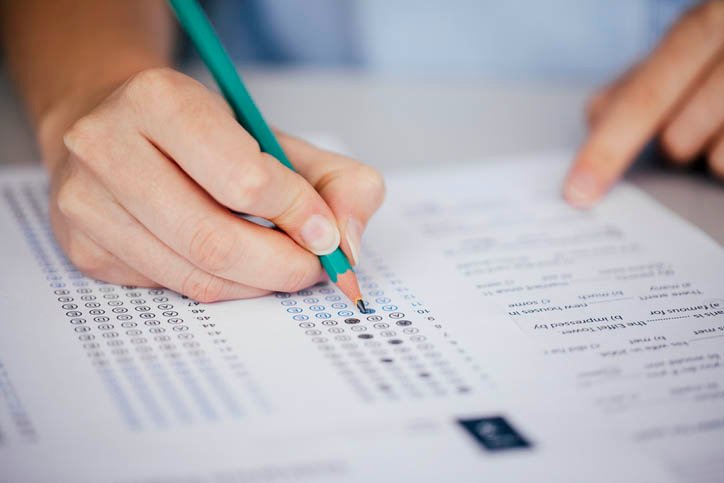 Close up of hands of student doing test.